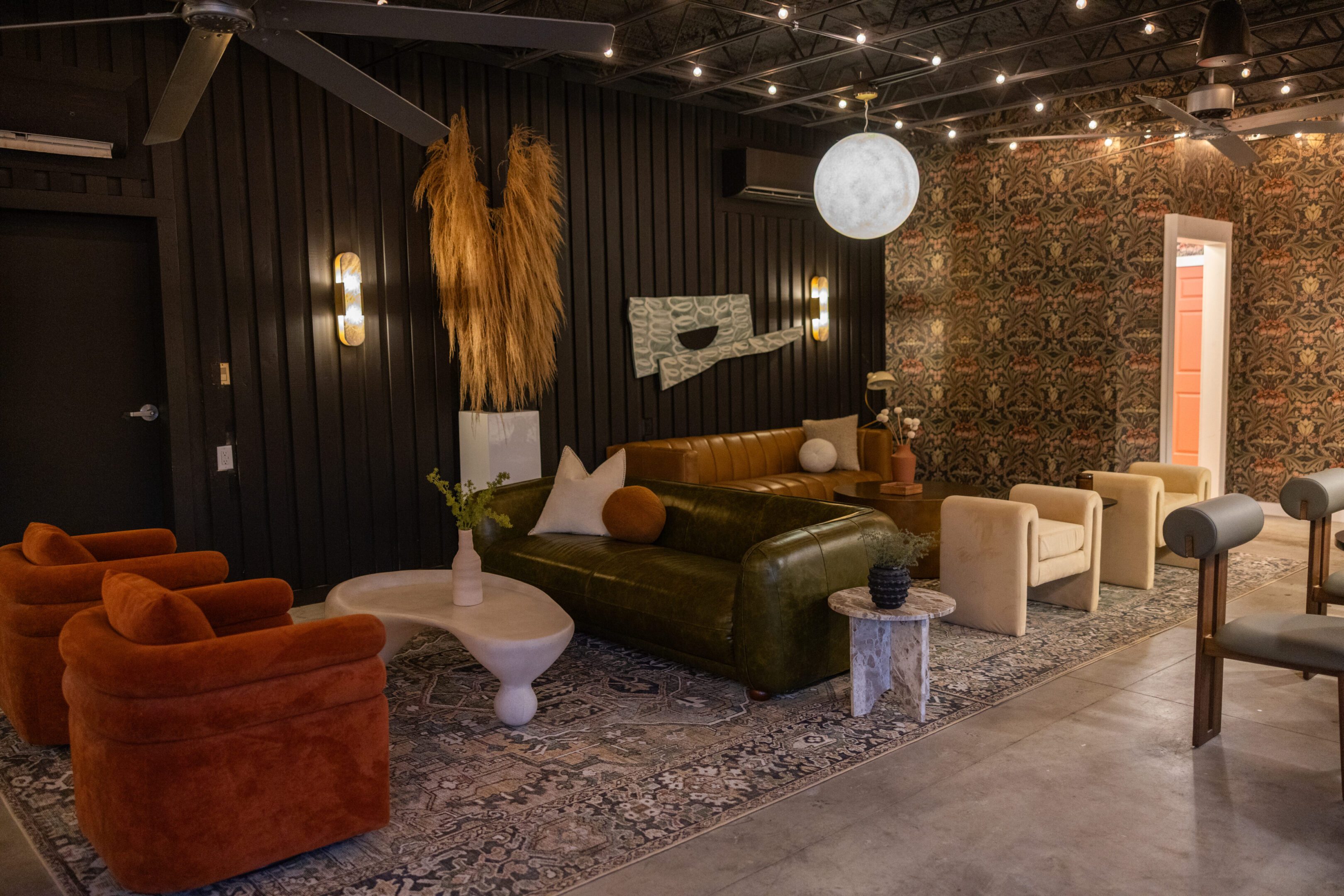 Cozy living room with eclectic furniture and warm lighting.