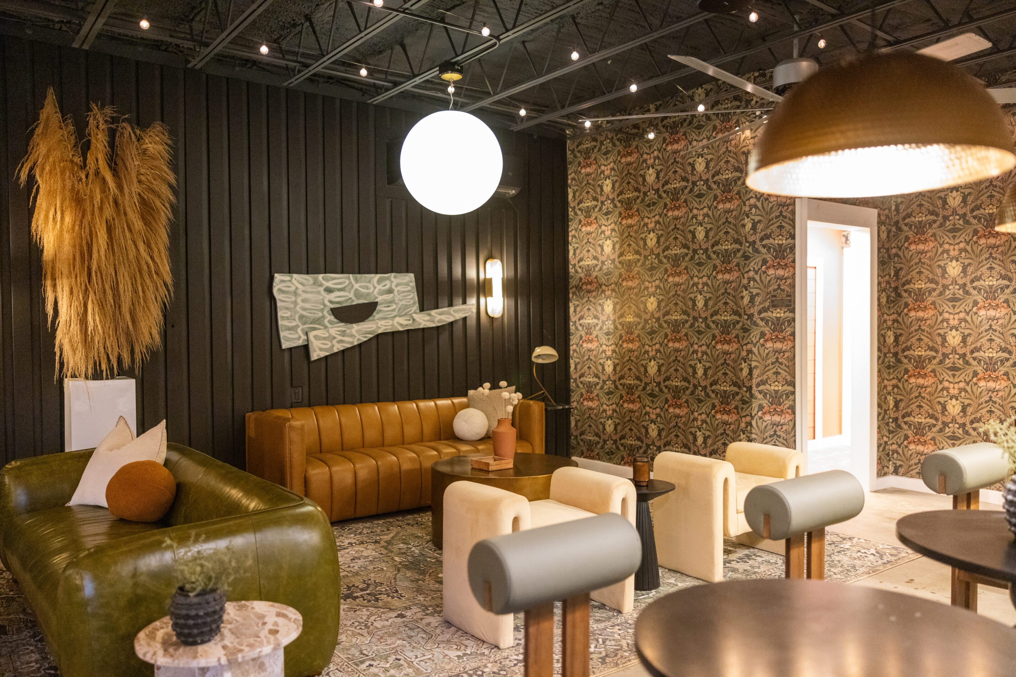Cozy modern lounge with leather sofas and warm lighting.