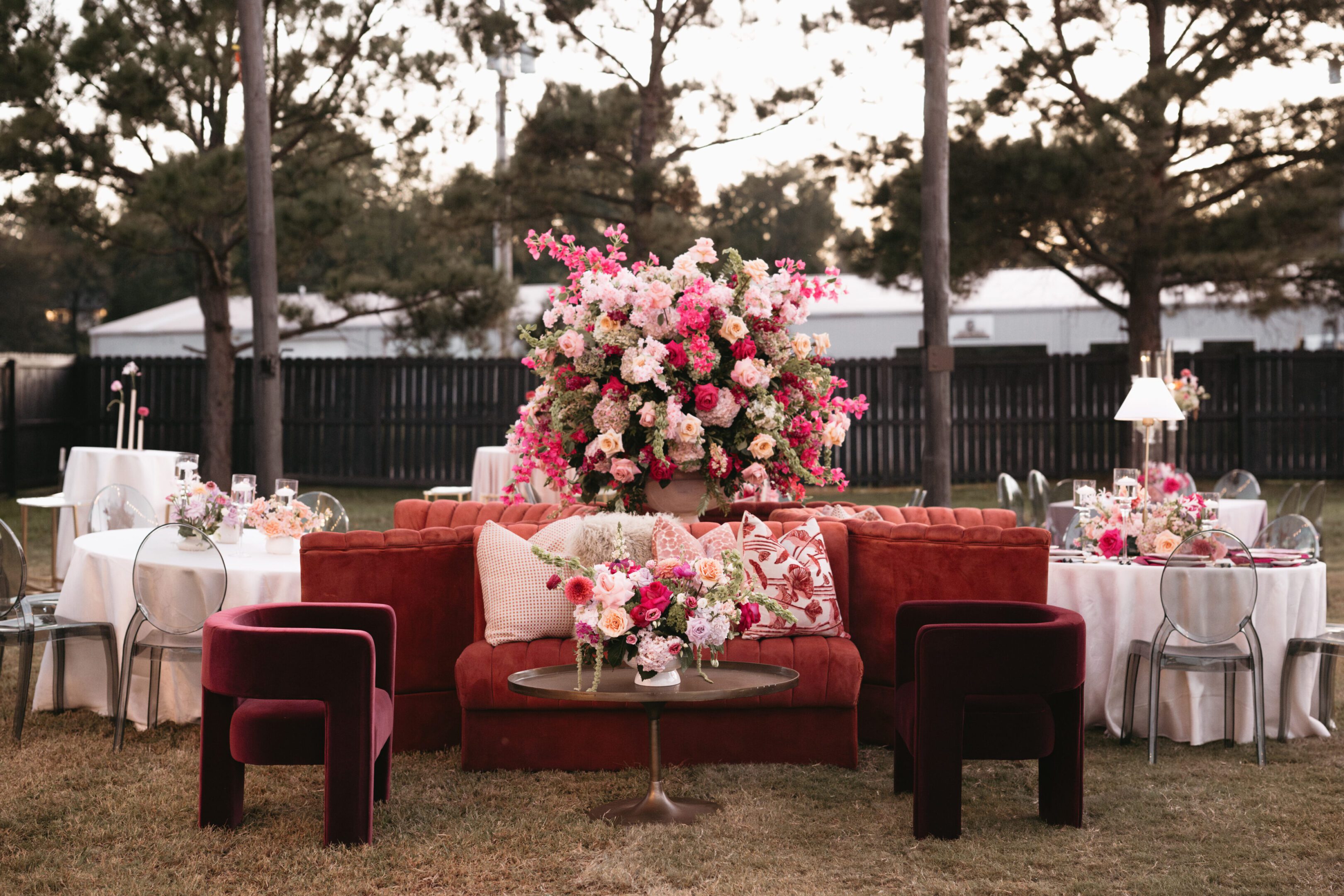 Elegant floral centerpiece on a rustic outdoor seating arrangement.