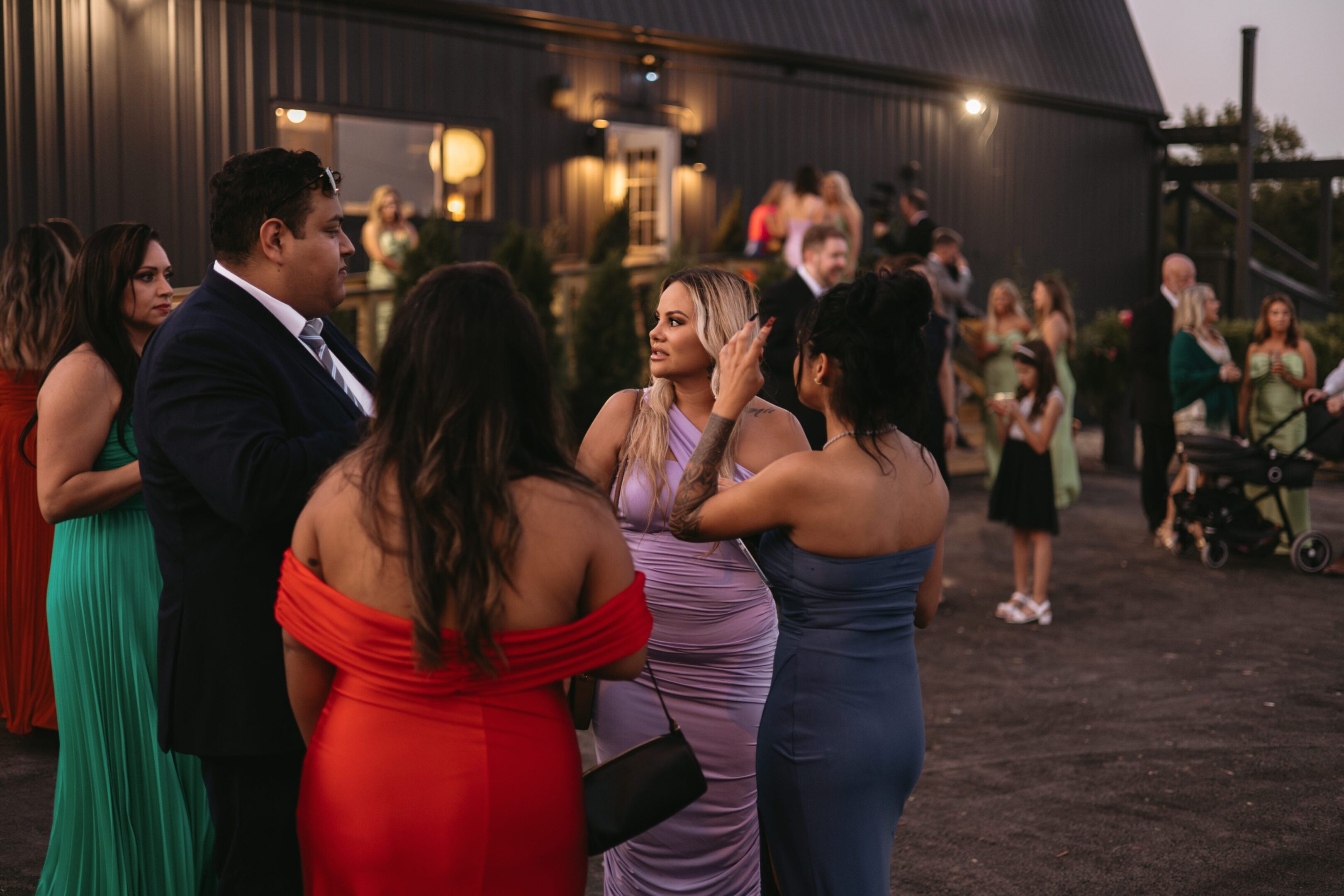 Guests dressed elegantly at an evening event.