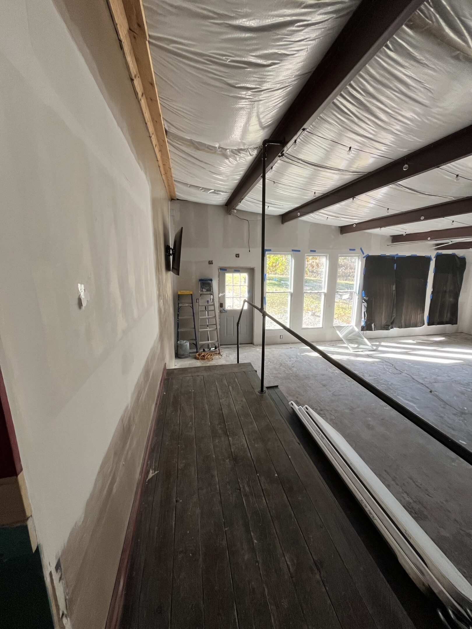 Interior of a room under construction with exposed ceilings and unfinished walls.