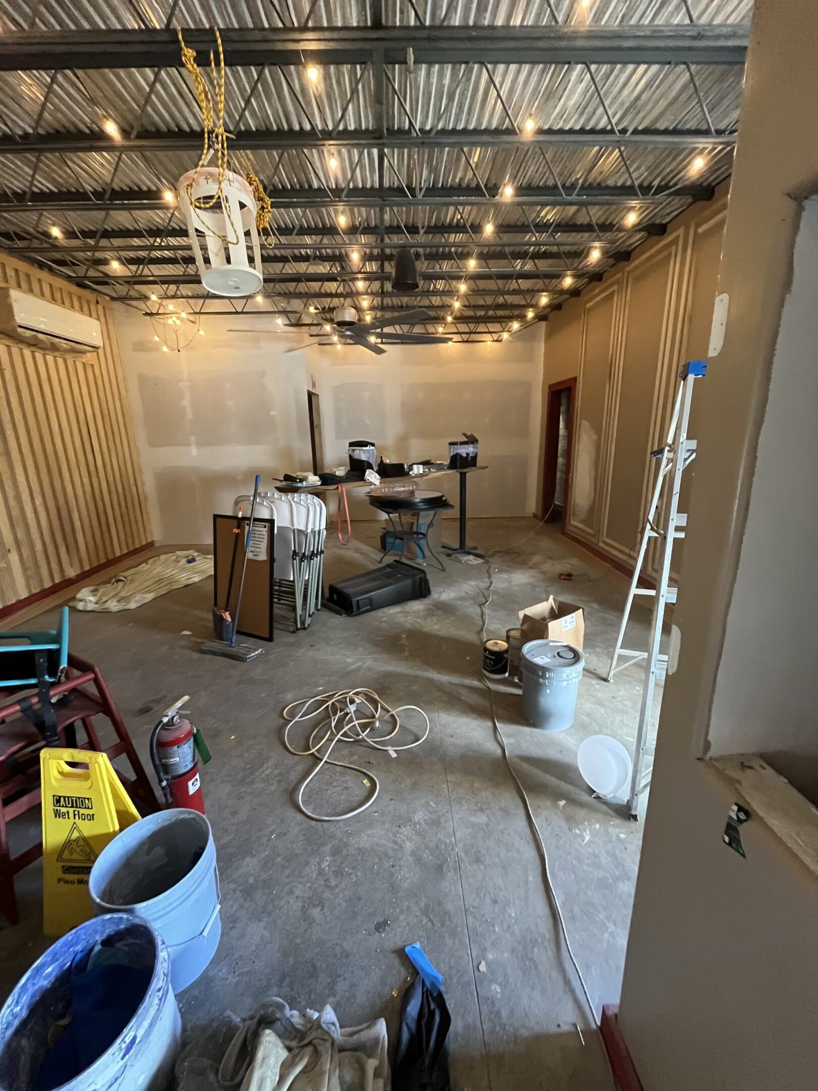 Interior of a room under renovation with construction materials scattered.