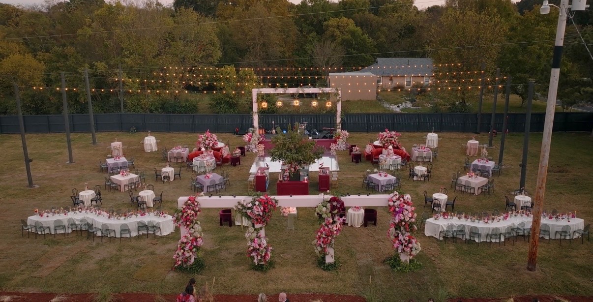 Outdoor wedding ceremony setup with floral decorations and chairs.