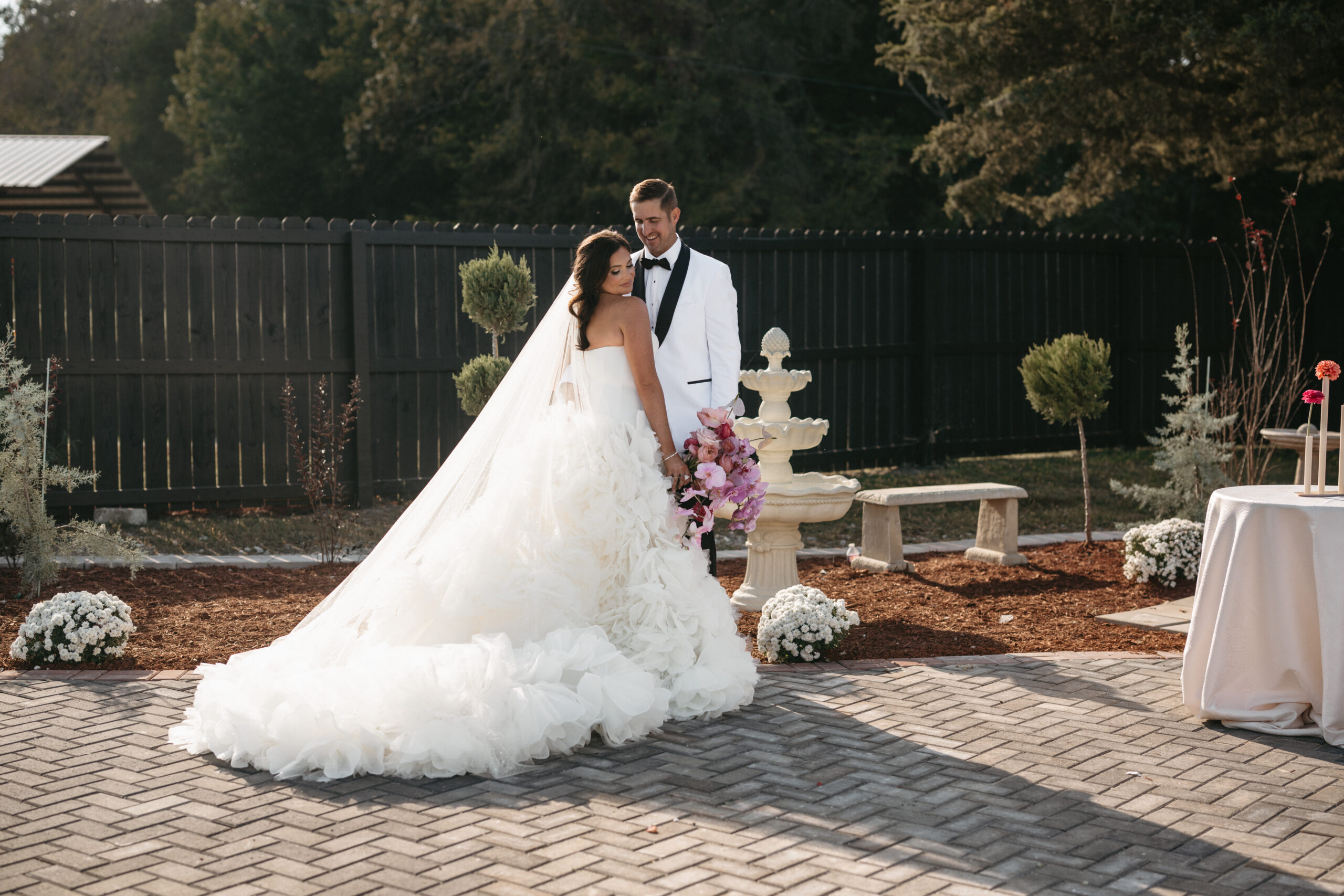 Bride and groom posing outdoors on their wedding day.