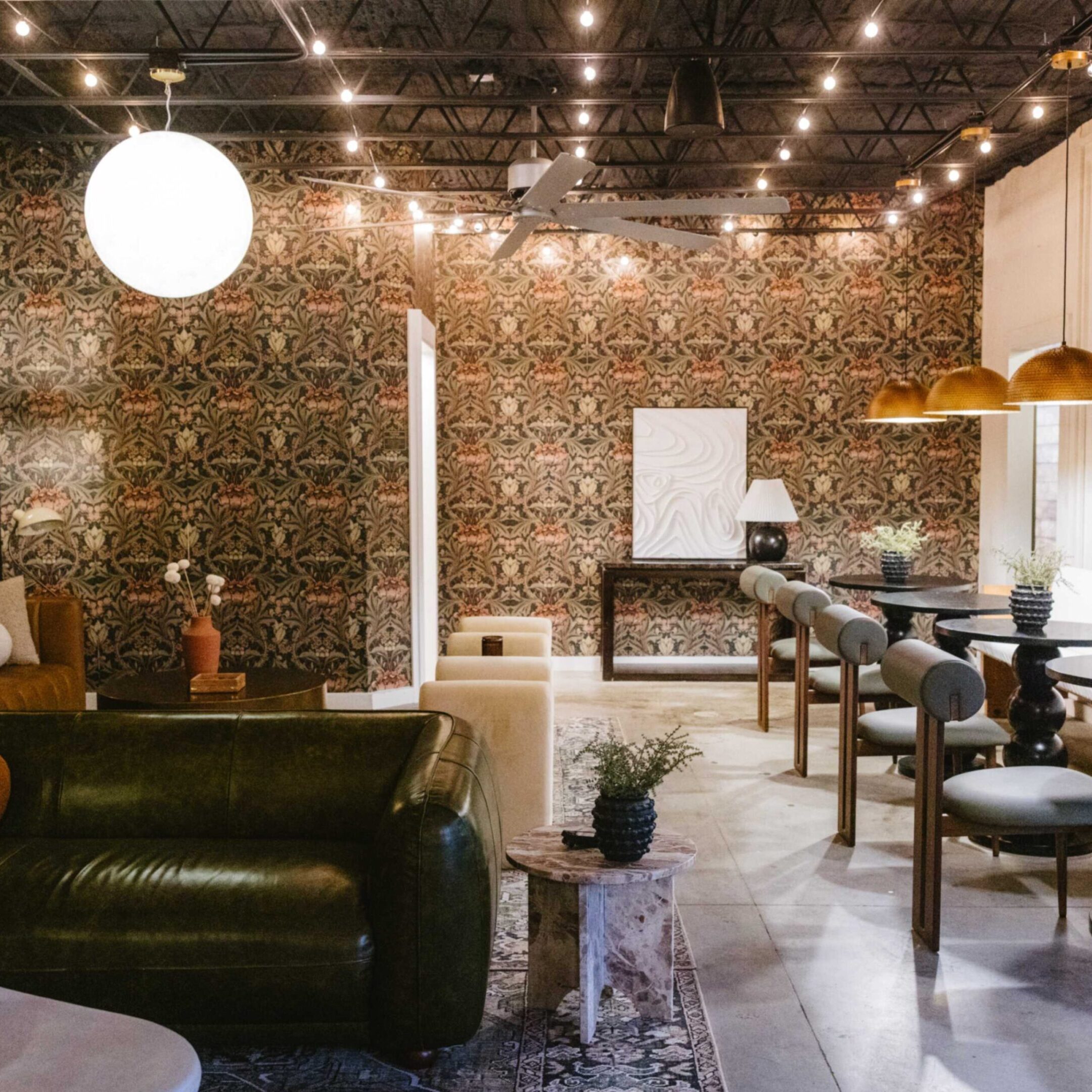 Stylish and cozy cafe interior with warm lighting and comfortable seating.